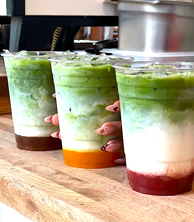 Layered matcha drinks lined up at Noe Cafe.